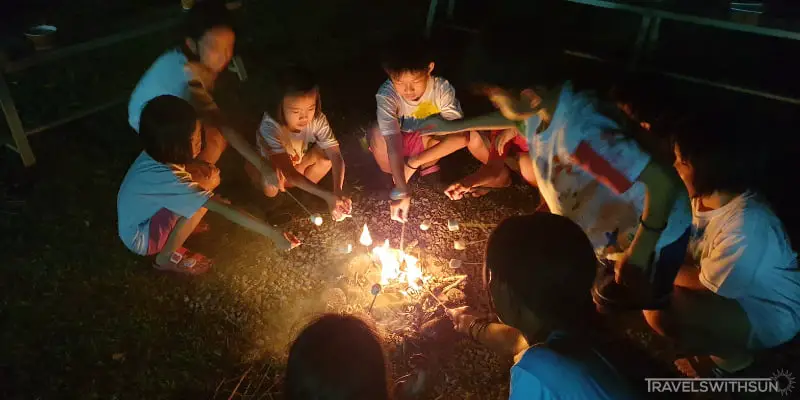 Children Roasting Marshmallows At The Little Habitat Camping Site, Bentong