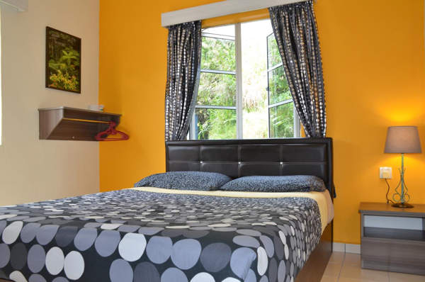 Double bed with shared bathroom at Father's Guest House