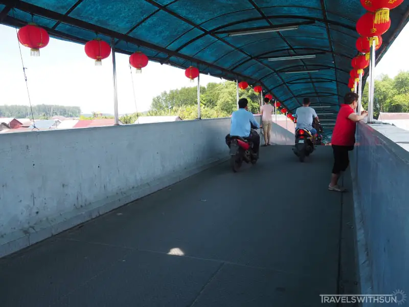 Locals Crossing The Port Weld Scenic Bridge In Kuala Sepetang