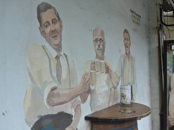 Mural of old men enjoying beer outside Kafe Yoon Wah in Ipoh