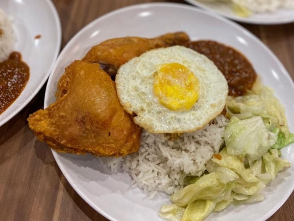 Plate Of Fried Chicken And Rice With Vegetables And A Sunny Side Up At Lim Fried Chicken