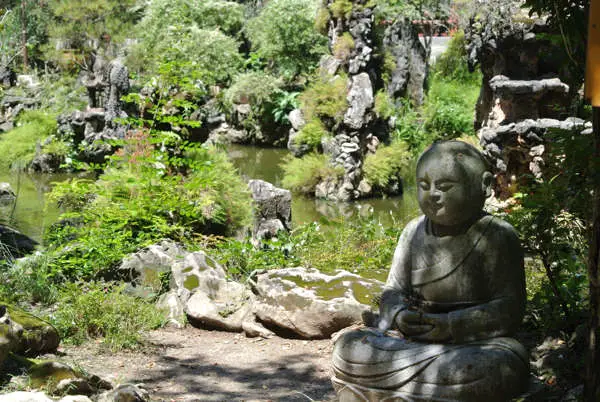 Statue In The Peaceful Garden Of Sam Poh Tong Cave Temple In Ipoh