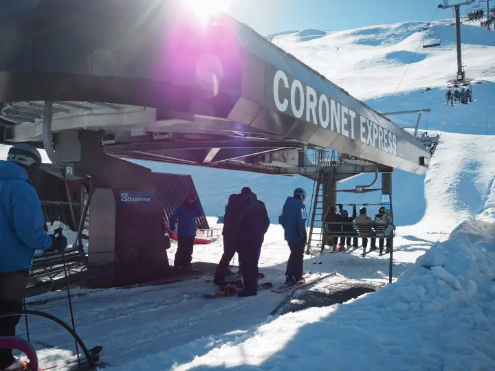 The Coronet Express ski lift at Coronet Peak ski resort - learn what to expect when skiing for the first time in New Zealand on www.travelswithsun.com