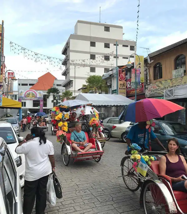 Trishaws Going Down Little India Penang